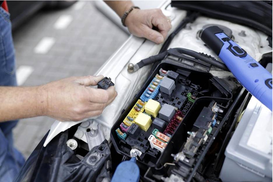 Technician testing EV battery
